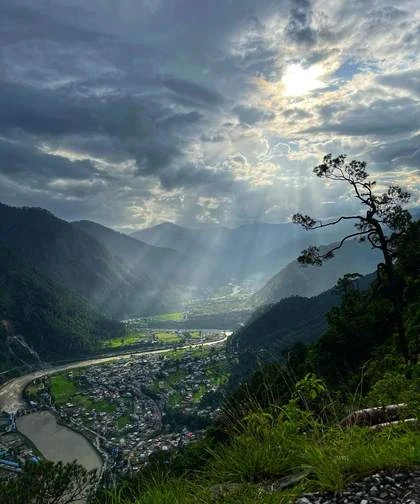 Light breaking through clouds over a valley